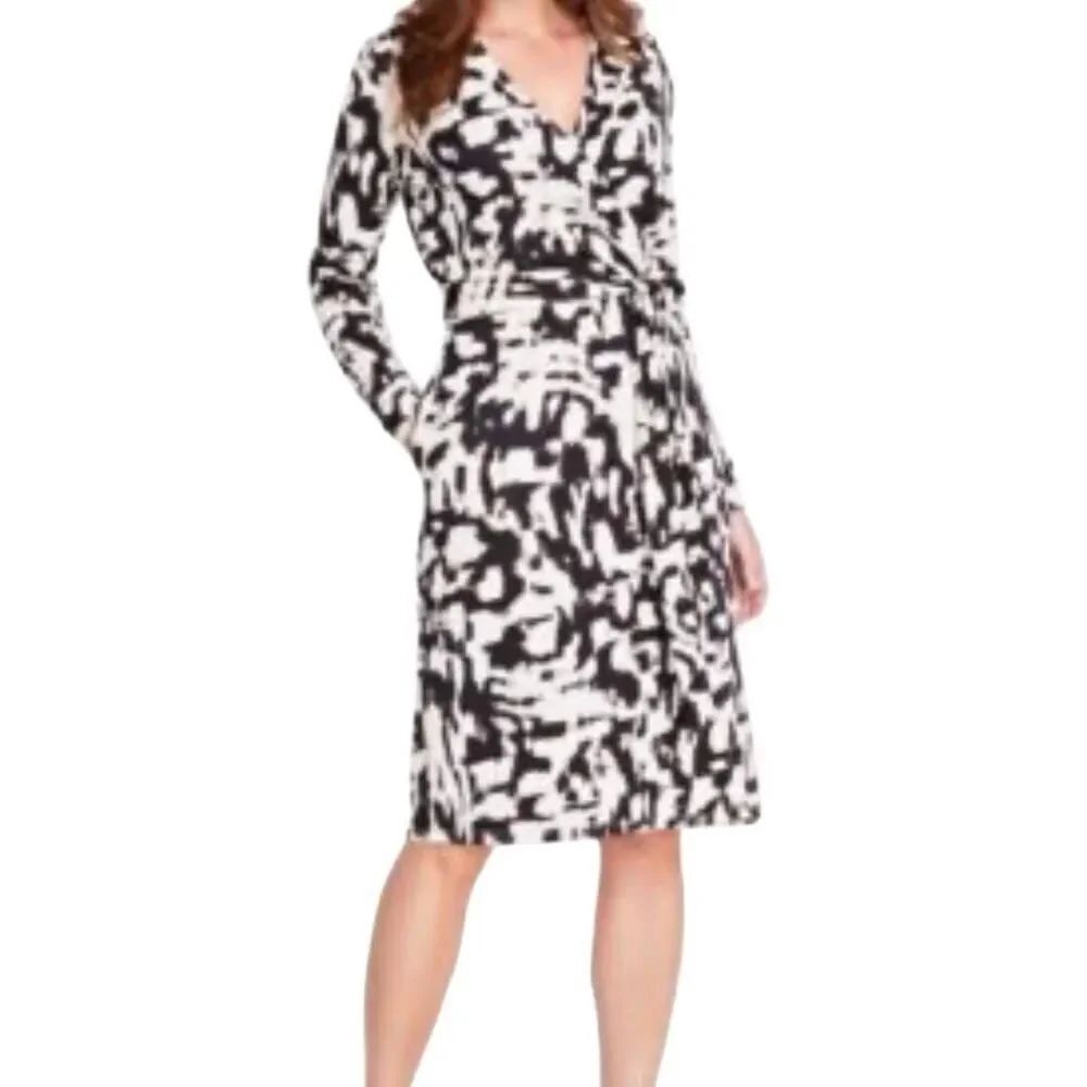 I.N.C. International Concepts adorns this sleek black and white wrap dress with